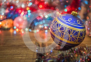 Close-up decorated blue christmas ball on bokeh background