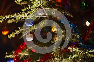 Close up of the decorated christmas tree with colorful balls or baubles