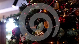 Close-up of decorated Christmas tree with garland. Frame. Beautiful Christmas tree decorated with colorful balls and
