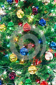 Close up of a decorated Christmas tree with lights and ornaments