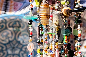 Close-up of decorative pendant made of colored stones for sale in the souk of the Medina in Marrakesh, Morocco