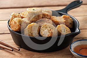 Close up Deep-fried crab Meat Rolls in a Black pan