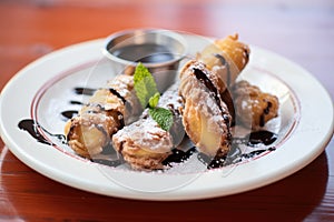 close-up of deep-fried oreos with hot fudge drizzle