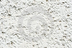 Close-up Deep texture of white-painted porous stone on the facade of the building. Stoned wall background texture