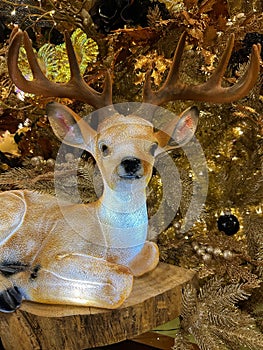 Close up of deer decoration in front of christmas tree