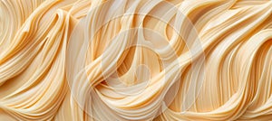 Close up of delicate liquid caramel swirls with smooth lines as background texture