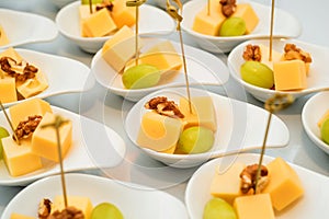 Appetizer of cheese cubes, grapes and walnut