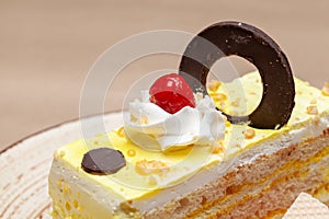 Close-up of a Delicious Butterscotch pastry with a chocolate wafer on top.