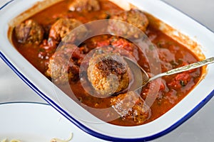 Close up of delicious homemade meat balls in tomato sauce.