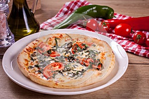 Close up of delicious italian pizza with vegetables & cheese