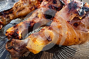 Close-up of delicious, newly grilled chicken thighs on a glass plate