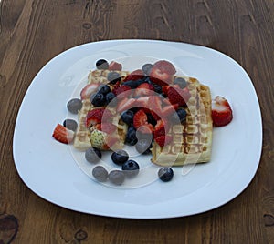 Close-up delicious pancakes, with fresh blueberries, strawberries