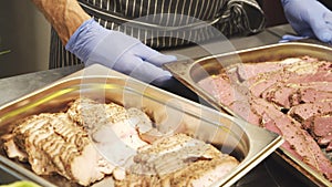 Close-up of delicious pieces of pastrami meat on a tray in the kitchen.