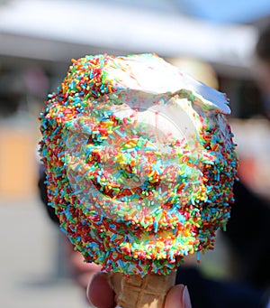 a close-up of a delicious soft ice cream with colorful sugar sprinkles