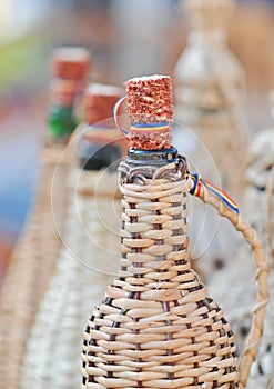 Close up of demijohn bottles with corn cob plug at souvenir market in Romania