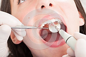 Close-up of dental inspection with orthodontist mirror