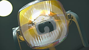 Close-up dental lamp turning on lighting indoors. Closeup of professional modern stomatological equipment in hospital