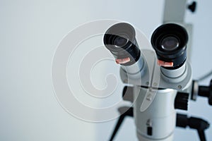 Close-up of a dental microscope on a white background.