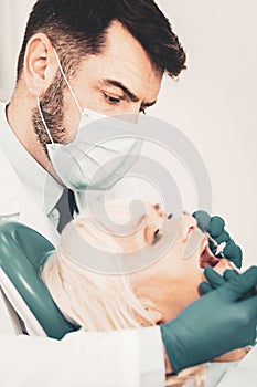 Close up of dentist examining patients teeth