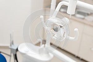 Close-up dentist lamp. Dental work in clinic. Operation, tooth replacement. Medicine, health, stomatology concept