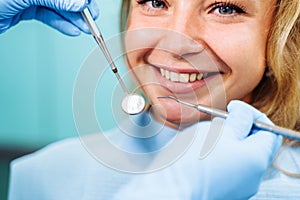 Close-up of the dentist`s hands with medical devices. Large detail - dentist`s mirror, curling and probe. Resolving dental