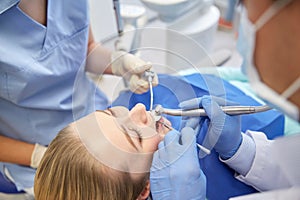 Close up of dentist treating female patient teeth