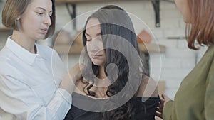 Close-up of depressed beautiful young woman listening to friends talking and shaking head. Portrait of frustrated