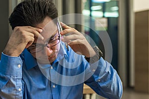 Close up of depressed and frustrated businessman on the phone. Bad news. Worried young businessman