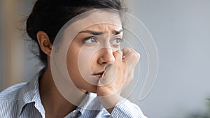 Close up depressed unhappy Indian woman thinking about problems photo