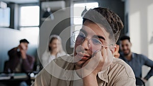 Close-up depressed worried young caucasian guy student sitting at desk alone suffering from bullying mistreatment by