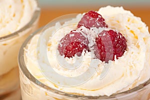 Close up desert with raspberries and cream