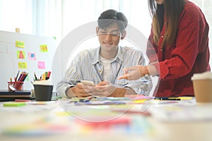 Close up of designers discussing app layout and interface wireframes during a brainstorming session