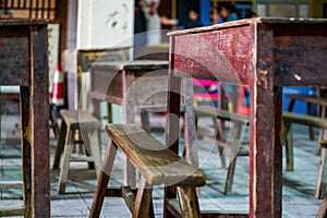 Close-up of desks and chairs in school classrooms in poor areas