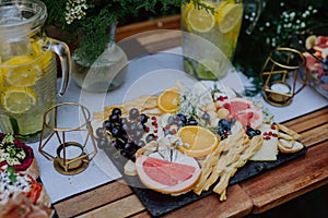 Close-up of dessert buffet at small wedding reception outside in the backyard. photo