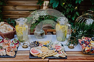 Close-up of dessert buffet at small wedding reception outside in the backyard. photo