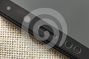Close-up detai view of cellphone front camera, sensors and loudspeaker. Modern technology and smartphone design concept