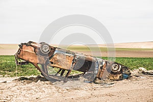 Close up detail of abandoned rusty burnt car wreck.