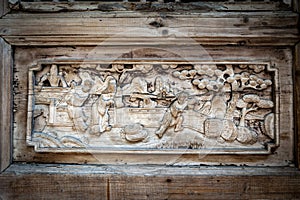 Close-up detail of ancient classic wooden door panel decorated with typical Chinese architecture style pattern and woodcarving