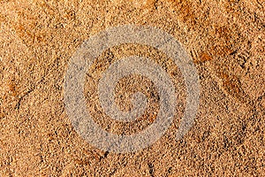Close-up detail of a baseball stadium's infield clay surface.