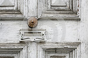 Beautiful old timber door with ornate metal doorknobs photo
