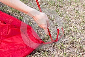 Close up detail of camping tent. Aluminum tent poles. Process of installing tent, setting up tent outdoors