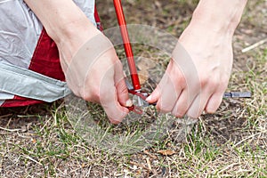 Close up detail of camping tent. Aluminum tent poles. Process of installing tent, setting up tent outdoors