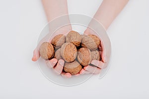 close up, Detail of child's hands, holding of organic walnuts.