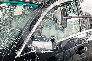 Close up detail of cleaning brush on car at carwash