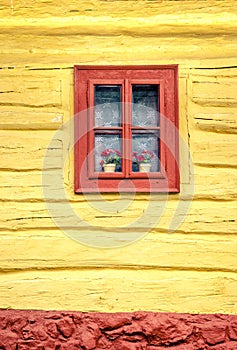 Close-up detail of colorful window on wooden cottage