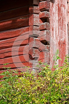 Close-up detail of a corner of an old red log house