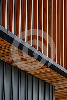 close up detail of dark grey alucobond cladding on the roof, wood slats behind it, contemporary architecture