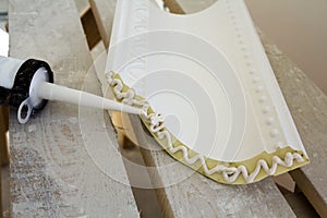 Close-up detail of decoration molding with glue adhesive before installation in interior renovation.