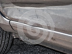Close up detail of a dented driver door from a car crash or automobile accident. photo