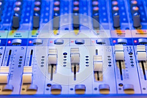 Close up detail of a desk mixer for mixing audio